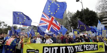 Demonstrators hold a banner during a Peoples Vote anti-Brexit march in London, Saturday, March 23, 2019. The march, organized by the People's Vote campaign is calling for a final vote on any proposed Brexit deal. This week the EU has granted Britain's Prime Minister Theresa May a delay to the Brexit process. (AP Photo/Kirsty Wigglesworth)