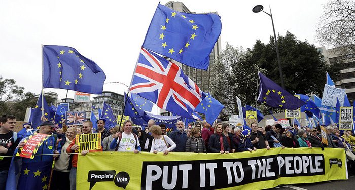 Demonstrators hold a banner during a Peoples Vote anti-Brexit march in London, Saturday, March 23, 2019. The march, organized by the People's Vote campaign is calling for a final vote on any proposed Brexit deal. This week the EU has granted Britain's Prime Minister Theresa May a delay to the Brexit process. (AP Photo/Kirsty Wigglesworth)