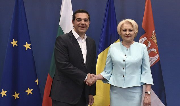 Greek Prime Minister Alexis Tsipras, left, shakes hands with his Romanian counterpart Viorica Dancila, during a meeting of the heads of government of Greece, Bulgaria, Romania and Serbia, at the northern port city of Thessaloniki , Greece, on Wednesday, July 4, 2018. (AP Photo/Giannis Papanikos)