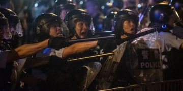 Riot police shout at protesters during clashes after a rally against a controversial extradition law proposal in Hong Kong on June 10, 2019. - Hong Kong witnessed its largest street protest in at least 15 years on June 9 as crowds massed against plans to allow extraditions to China, a proposal that has sparked a major backlash against the city's pro-Beijing leadership. (Photo by Philip FONG / AFP)