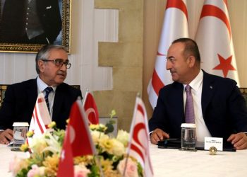 Turkish Foreign Minister Mevlut Cavusoglu, right, talks with Turkish Cypriot leader Mustafa Akinci during a meeting in the Turkish occupied area in the northern part of divided capital Nicosia, Cyprus, Monday, Sept. 9, 2019. Cavusoglu is in the northern part of divided Cyprus for three-day visit. (AP Photo/Petros Karadjias)