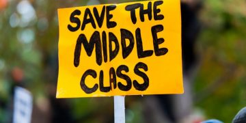 A protest sign reading "Save the Middle Class".