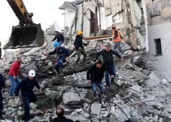 TOPSHOT - Emergency workers clear debris at a damaged building in Thumane, 34 kilometres (about 20 miles) northwest of capital Tirana, after an earthquake hit Albania, on November 26, 2019. - Four people died and some 150 were slightly injured in Albania after a 6.4 magnitude earthquake, the strongest in decades, rocked the Balkan country early Tuesday. The epicentre of the quake was about 34 kilometres (about 20 miles) northwest of Tirana, according to the European-Mediterranean Seismological Centre. (Photo by Gent SHKULLAKU / AFP) (Photo by GENT SHKULLAKU/AFP via Getty Images)