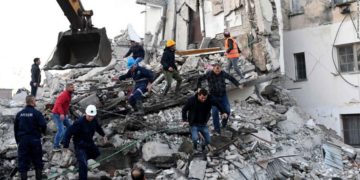 TOPSHOT - Emergency workers clear debris at a damaged building in Thumane, 34 kilometres (about 20 miles) northwest of capital Tirana, after an earthquake hit Albania, on November 26, 2019. - Four people died and some 150 were slightly injured in Albania after a 6.4 magnitude earthquake, the strongest in decades, rocked the Balkan country early Tuesday. The epicentre of the quake was about 34 kilometres (about 20 miles) northwest of Tirana, according to the European-Mediterranean Seismological Centre. (Photo by Gent SHKULLAKU / AFP) (Photo by GENT SHKULLAKU/AFP via Getty Images)