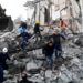 TOPSHOT - Emergency workers clear debris at a damaged building in Thumane, 34 kilometres (about 20 miles) northwest of capital Tirana, after an earthquake hit Albania, on November 26, 2019. - Four people died and some 150 were slightly injured in Albania after a 6.4 magnitude earthquake, the strongest in decades, rocked the Balkan country early Tuesday. The epicentre of the quake was about 34 kilometres (about 20 miles) northwest of Tirana, according to the European-Mediterranean Seismological Centre. (Photo by Gent SHKULLAKU / AFP) (Photo by GENT SHKULLAKU/AFP via Getty Images)