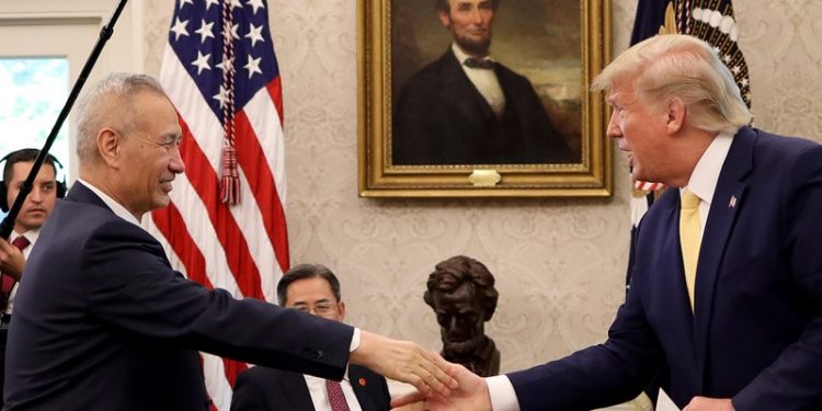 President Trump shakes hands with Chinese Vice Premier Liu He at the White House after announcing a "phase one" trade agreement with China on Oct. 11, 2019. The two leaders are meeting again in Washington on Wednesday to sign the deal.