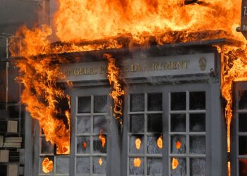 A Los Angeles Police Department kiosk is seen ablaze in The Grove shopping center during a protest over the death of George Floyd, Saturday, May 30, 2020, in Los Angeles. Protests were held in U.S. cities over the death of Floyd, a black man who died after being restrained by Minneapolis police officers on May 25.  (AP Photo/Mark J. Terrill)