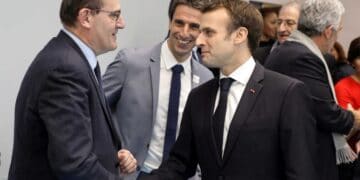 FILE PHOTO: French President Emmanuel Macron shakes hands with Interministerial Delegate for the Olympic and Paralympic Games 2024 Jean Castex (L) flanked by President of the Paris Organising Committee of the 2024 Olympic and Paralympic Games Tony Estanguet during the inauguration of a new handball complex in Creteil, on the outskirts of Paris, France January 9, 2019. Ludovic Marin/Pool via REUTERS/File Photo