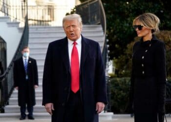 President Donald Trump and first lady Melania Trump stop to talk with the media as they walk to board Marine One on the South Lawn of the White House, Wednesday, Jan. 20, 2021, in Washington. Trump is en route to his Mar-a-Lago Florida Resort. (AP Photo/Alex Brandon)