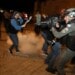 Israeli police officer stands in position as a stun grenade explodes by the gate to Jerusalem's Old City during clashes, as the Muslim holy fasting month of Ramadan continues, in Jerusalem April 24, 2021. REUTERS/Ammar Awad