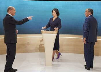 From left, Chancellor candidates Olaf Scholz (SPD), Annalena Baerbock (Green Party) and Armin Laschet (CDU) stand in the TV studio in Berlin, Sunday, Sept. 12, 2021. With two weeks left before Germany’s national election, the three candidates for chancellorship are facing off Sunday in the second of three televised election debates. (Michael Kappeler/Pool via AP)