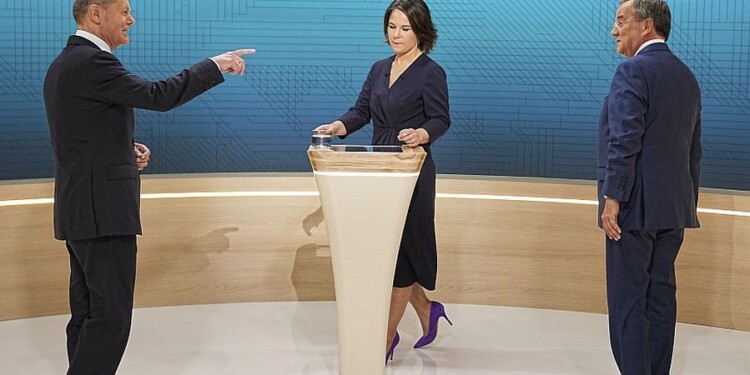 From left, Chancellor candidates Olaf Scholz (SPD), Annalena Baerbock (Green Party) and Armin Laschet (CDU) stand in the TV studio in Berlin, Sunday, Sept. 12, 2021. With two weeks left before Germany’s national election, the three candidates for chancellorship are facing off Sunday in the second of three televised election debates. (Michael Kappeler/Pool via AP)