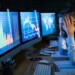 Frustrated and worried businessman with computer sitting at desk, working late. Financial crisis concept.