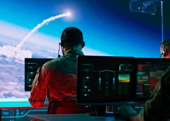 Zoom in view of military men using computers to watch online broadcast and launch nuclear missile during work in control center during world war