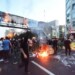 TOPSHOT - A picture obtained by AFP outside Iran on September 21, 2022, shows Iranian demonstrators burning a rubbish bin in the capital Tehran during a protest for Mahsa Amini, days after she died in police custody. Protests spread to 15 cities across Iran overnight over the death of the young woman Mahsa Amini after her arrest by the country's morality police, state media reported today.In the fifth night of street rallies, police used tear gas and made arrests to disperse crowds of up to 1,000 people, the official IRNA news agency said.
 (Photo by AFP)