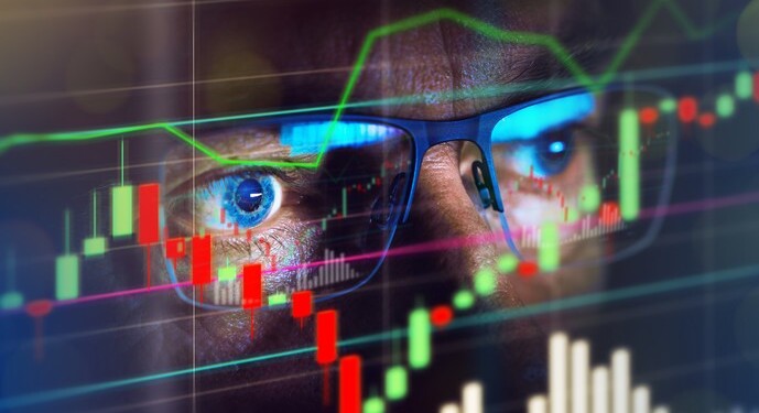 Close up of stock market trader looking at graph of share prices