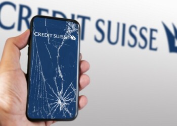 New York, US, March 2023: Hand holding a phone with the Credit Suisse logo on the cracked screen. In March 2023, Credit Suisse experienced a sharp drop in its stock price. Illustrative editorial