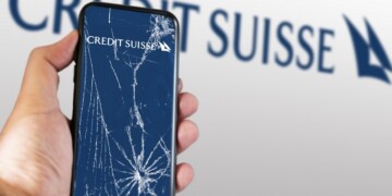 New York, US, March 2023: Hand holding a phone with the Credit Suisse logo on the cracked screen. In March 2023, Credit Suisse experienced a sharp drop in its stock price. Illustrative editorial