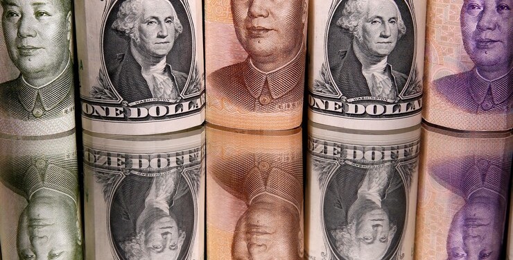 FILE PHOTO: Chinese Yuan and U.S. dollar banknotes are seen in this illustration taken February 10, 2020. REUTERS/Dado Ruvic/Illustration/File Photo