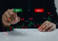 Finance graph with a businessman hand touching a button Stock market exchange future analysis investment forex virtual screen Business digital interface technology concept.