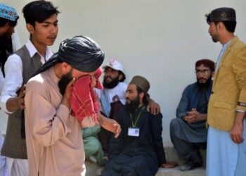 People mourn for their relative, who was killed in a bomb explosion, at a hospital, in Quetta, Pakistan, Friday, Sept. 29, 2023. A powerful bomb exploded at a rally celebrating the birthday of Islam's Prophet Muhammad in southwest Pakistan on Friday, killing multiple people and wounding dozens of others, police and a government official said. (AP Photo/Arshad Butt)