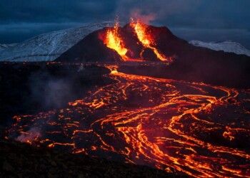 Lava flows from an eruption of a volcano on the Reykjanes Peninsula in southwestern Iceland on Monday, March 29, 2021. Iceland's latest volcano eruption is still attracting crowds of people hoping to get close to the gentle lava flows. (AP Photo/Marco Di Marco)