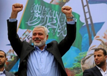 Palestinian top Hamas leader Ismail Haniyeh greets supporters during a rally to commemorate the 27th anniversary of the Hamas militant group, at the main road in Jebaliya in the northern Gaza Strip, Friday, Dec. 12, 2014. (AP Photo/Adel Hana)