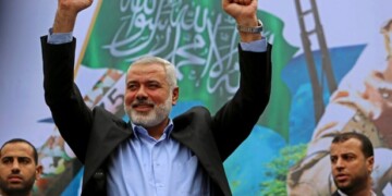 Palestinian top Hamas leader Ismail Haniyeh greets supporters during a rally to commemorate the 27th anniversary of the Hamas militant group, at the main road in Jebaliya in the northern Gaza Strip, Friday, Dec. 12, 2014. (AP Photo/Adel Hana)