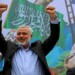 Palestinian top Hamas leader Ismail Haniyeh greets supporters during a rally to commemorate the 27th anniversary of the Hamas militant group, at the main road in Jebaliya in the northern Gaza Strip, Friday, Dec. 12, 2014. (AP Photo/Adel Hana)