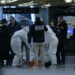 French forensic and judicial police work after a knife attack at Paris's Gare de Lyon railway station, a major travel hub on February 3, 2024. Police said that the suspected attacker had been arrested and that the motives behind the attack were unclear. The 8:00 am (0700 GMT) attack left one person with serious injuries while two others were lightly wounded. (Photo by Thomas SAMSON / AFP)