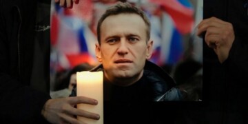 Protesters hold a picture of Alexei Navalny as they stage a demonstration opposite the Russian Embassy in London, Friday, Feb. 16, 2024, in reaction to the news that jailed Russian opposition leader Alexei Navalny has died in a Russian prison, according to the Federal Penitentiary Service. (AP Photo/Kin Cheung)