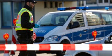 A German police officer checks vehicles at the German-France border in Kehl, Monday March 16, 2020. Germany partially closes its borders with France, Switzerland, Austria, Luxembourg and Denmark as it steps up efforts to stem the spread of the new coronavirus. For most people, the new coronavirus causes only mild or moderate symptoms. For some it can cause more severe illness. (AP Photo/Jean-Francois Badias)