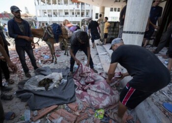 Palestinians search for bodies in the rubble of a school destroyed in an Israeli airstrike on Deir al-Balah, central Gaza Strip, Saturday, July 27, 2024. (AP Photo/Abdel Kareem Hana)