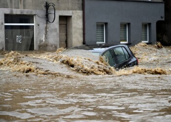 A car is submerged in water in a flooded street in Glucholazy, southern Poland, on September 15, 2024. One person has drowned in Poland and an Austrian fireman has died responding to floods, authorities said, as Storm Boris lashed central and eastern Europe with torrential rains. Since Thursday, September 12, 2024, swathes of Austria, the Czech Republic, Hungary, Romania and Slovakia have been hit by high winds and unusually fierce rainfall. The storm had already caused the death of five people in Romania, and thousands have been evacuated from their homes across the continent. (Photo by Sergei GAPON / AFP)