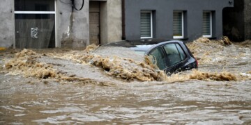 A car is submerged in water in a flooded street in Glucholazy, southern Poland, on September 15, 2024. One person has drowned in Poland and an Austrian fireman has died responding to floods, authorities said, as Storm Boris lashed central and eastern Europe with torrential rains. Since Thursday, September 12, 2024, swathes of Austria, the Czech Republic, Hungary, Romania and Slovakia have been hit by high winds and unusually fierce rainfall. The storm had already caused the death of five people in Romania, and thousands have been evacuated from their homes across the continent. (Photo by Sergei GAPON / AFP)