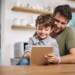 Shot of a single father sitting with his son while using a digital tablet