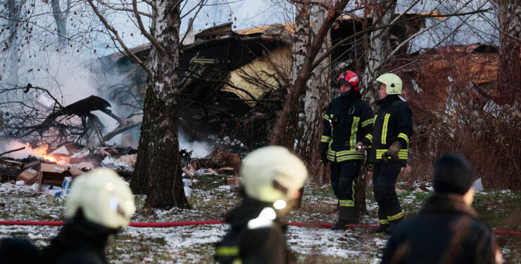 Emergency services at the DHL cargo plane crash site near Vilnius International Airport on Nov. 25. Photographer: Petras Malukas/AFP/Getty Images