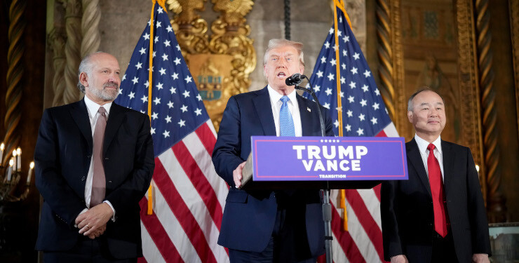 Donald Trump delivers remarks alongside Howard Lutnick, left, and Masayoshi Son at the Mar-a-Lago resort in Palm Beach, Florida, on Dec. 16. Photographer: Andrew Harnik/Getty Images