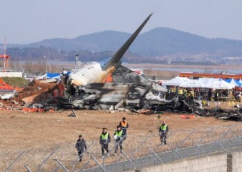 Firefighters and rescue team members work near the wreckage of a passenger plane at Muan International Airport in Muan, South Korea, Sunday, Dec. 29, 2024. (AP Photo/Ahn Young-joon)