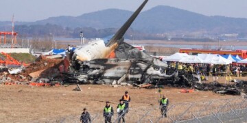 Firefighters and rescue team members work near the wreckage of a passenger plane at Muan International Airport in Muan, South Korea, Sunday, Dec. 29, 2024. (AP Photo/Ahn Young-joon)