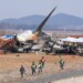 Firefighters and rescue team members work near the wreckage of a passenger plane at Muan International Airport in Muan, South Korea, Sunday, Dec. 29, 2024. (AP Photo/Ahn Young-joon)