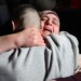 A Palestinian woman embraces her freed son upon his arrival among some 90 prisoners set free by Israel in the early hours of January 20, 2025, in the occupied West Bank town of Beitunia, on the outskirts of Ramallah. Crowds cheered, chanted and honked car horns as two buses carrying the prisoners arrived in Beitunia following their release as part of the Gaza ceasefire deal that began on January 19 and saw three Israeli hostages freed by Hamas in the Gaza Strip. (Photo by Zain JAAFAR / AFP)