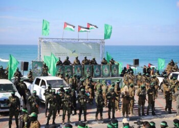 Hamas fighters deploy at the stage where the hand over of American-Israeli hostage Keith Siegel, 65, to the Red Cross will take place in Gaza City, Saturday Feb.1, 2025.(AP Photo/Mohammed Hajjar)