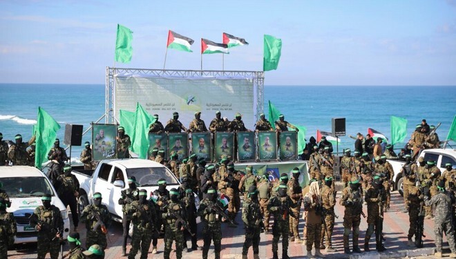 Hamas fighters deploy at the stage where the hand over of American-Israeli hostage Keith Siegel, 65, to the Red Cross will take place in Gaza City, Saturday Feb.1, 2025.(AP Photo/Mohammed Hajjar)