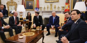 France's President Emmanuel Macron, from center to right, President Donald Trump, Vice President JD Vance and Secretary of State Marco Rubio attend a meeting in the Oval Office of the White House in Washington, Monday, Feb. 24, 2025. (Ludovic Marin/Pool via AP)