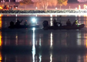 Boats work the scene in the Potomac River near Ronald Reagan Washington National Airport, Thursday, Jan. 30, 2025, in Arlington, Va. (AP Photo/Alex Brandon)